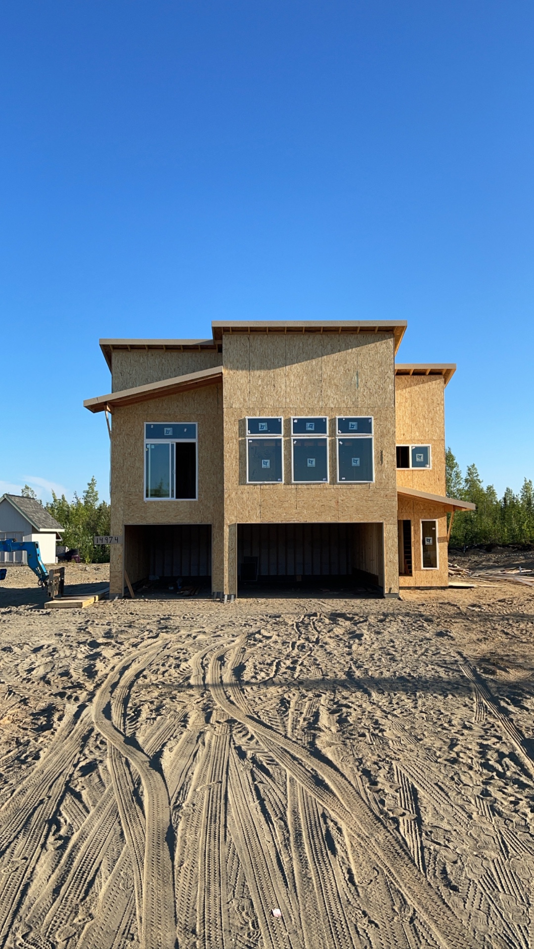 Modern two-story custom home framed and sheathed with windows installed